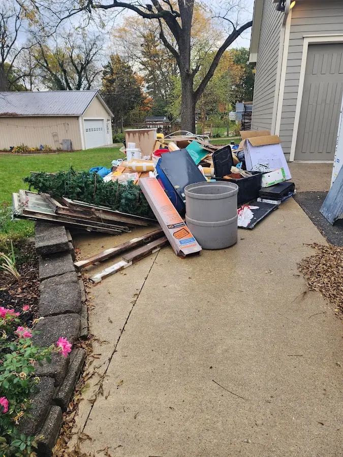 Dumpster being loaded with debris for Roofing Dumpster Rental in Emmett